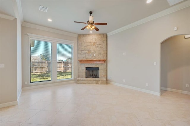 unfurnished living room featuring ceiling fan, a fireplace, light tile patterned floors, and crown molding