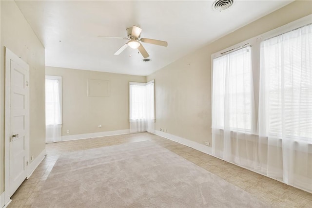 spare room featuring light carpet and ceiling fan