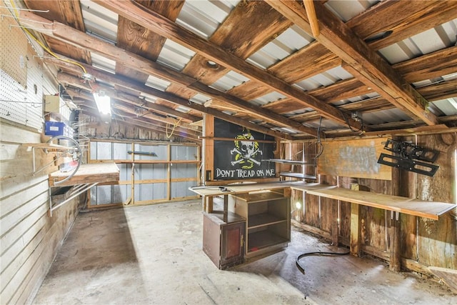 interior space featuring lofted ceiling and concrete floors