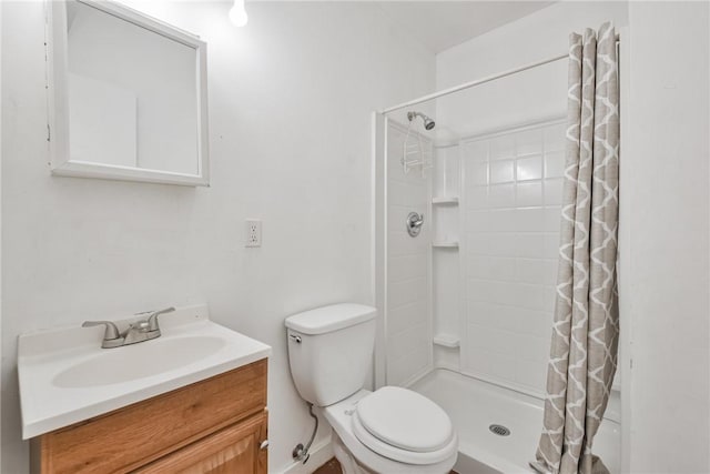 bathroom featuring walk in shower, vanity, and toilet