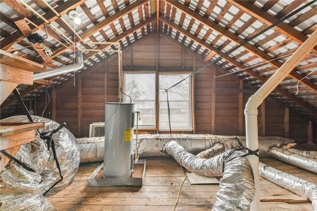 unfinished attic featuring water heater