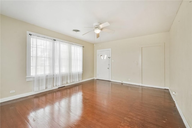 empty room with wood-type flooring and ceiling fan