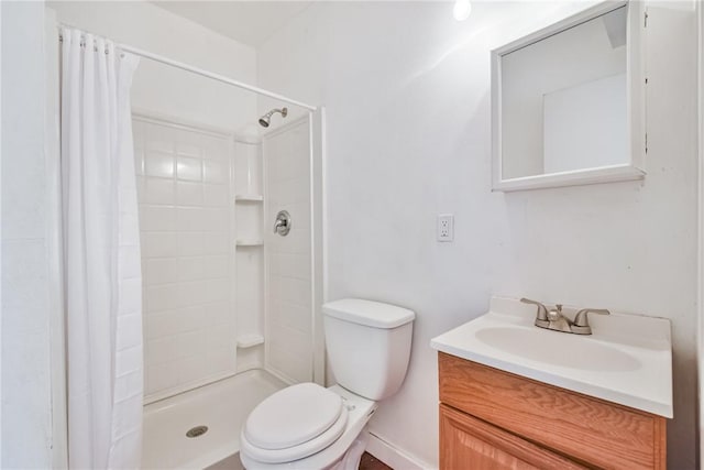 bathroom with vanity, a shower with shower curtain, and toilet