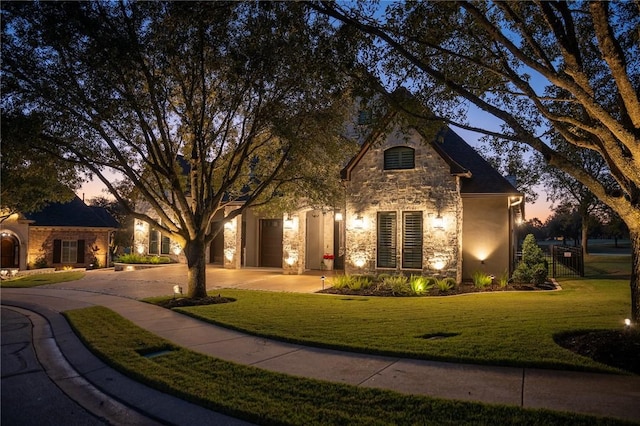 view of front of property with a garage and a yard