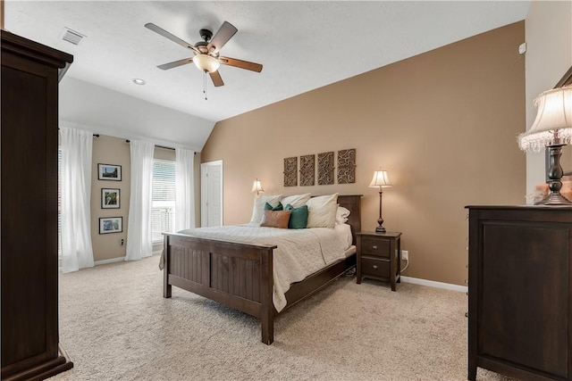 bedroom featuring visible vents, light carpet, vaulted ceiling, ceiling fan, and baseboards