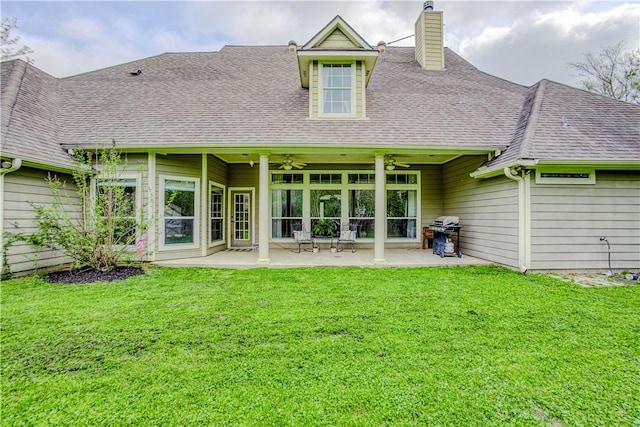 back of property with a shingled roof, a yard, a patio, and ceiling fan