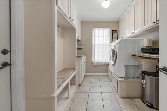 laundry room with crown molding, laundry area, washer / dryer, and baseboards