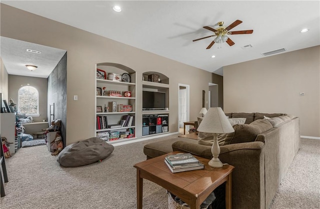 carpeted living room featuring a ceiling fan, recessed lighting, visible vents, and built in features