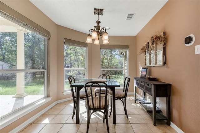 dining area featuring visible vents, a notable chandelier, baseboards, and light tile patterned floors