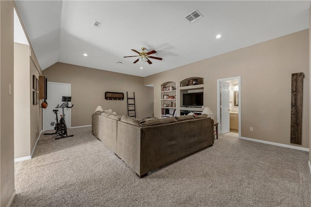 living room with built in shelves, visible vents, a ceiling fan, and light colored carpet