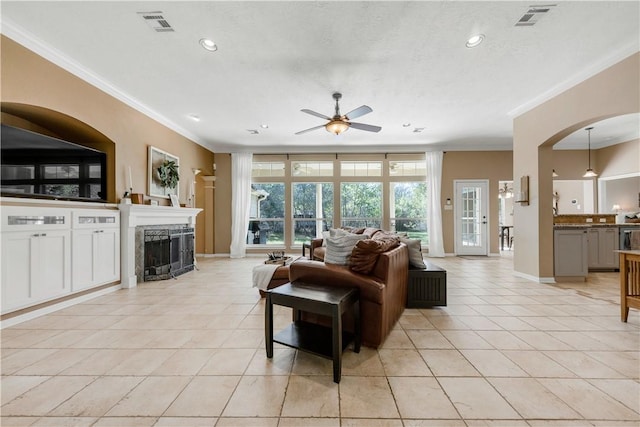 living room with ornamental molding, visible vents, and light tile patterned floors