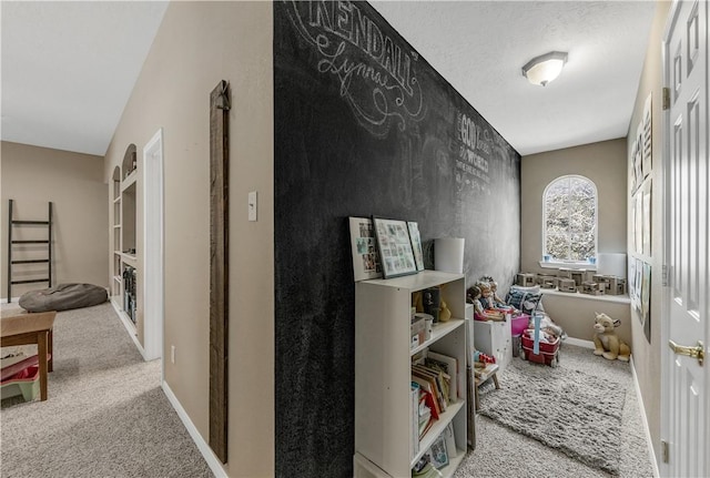 interior space featuring carpet floors and baseboards