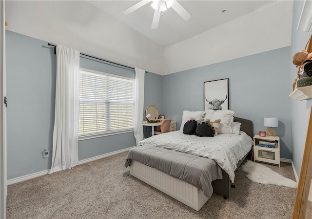 bedroom with light carpet, lofted ceiling, a ceiling fan, and baseboards