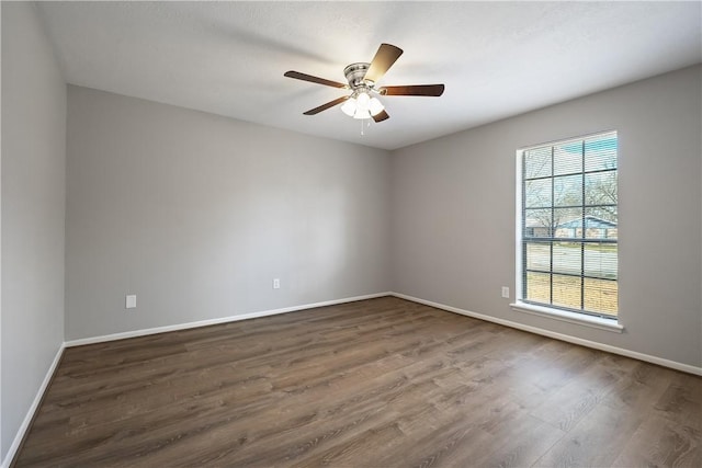 empty room featuring ceiling fan and dark hardwood / wood-style floors