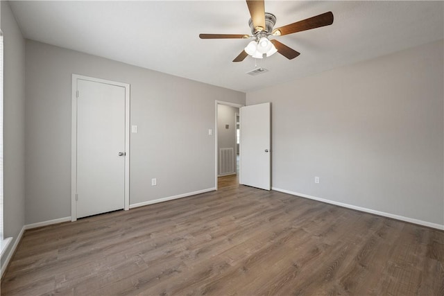 unfurnished bedroom featuring wood-type flooring and ceiling fan