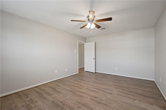 unfurnished room featuring hardwood / wood-style floors and ceiling fan