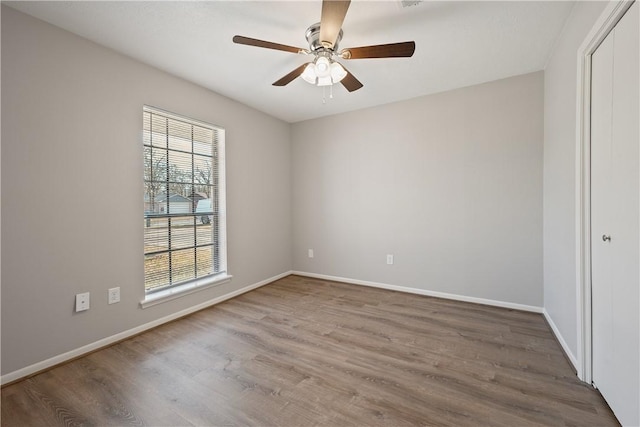 spare room with ceiling fan and hardwood / wood-style floors