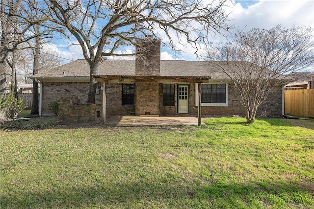 rear view of house featuring a patio area and a lawn