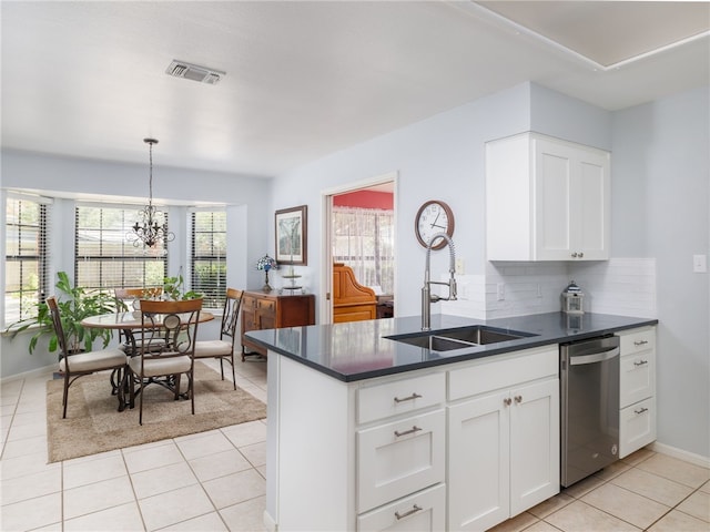 kitchen with backsplash, stainless steel dishwasher, sink, an inviting chandelier, and white cabinetry