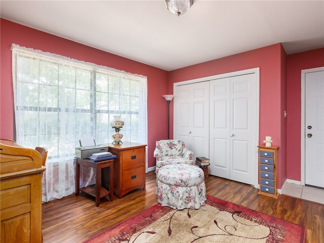 sitting room with dark hardwood / wood-style flooring