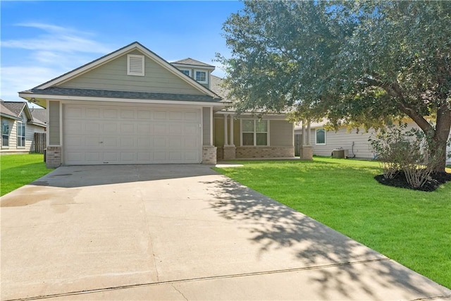 view of front of house featuring central AC, a front yard, and a garage