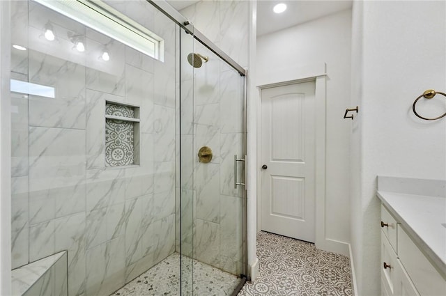 bathroom featuring vanity and a shower with shower door