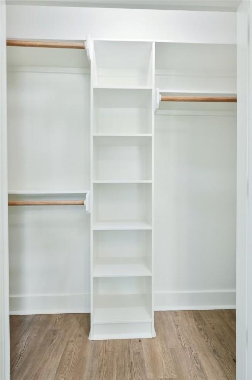 walk in closet featuring hardwood / wood-style flooring