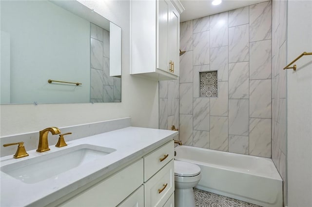 full bathroom featuring toilet, vanity, and tiled shower / bath