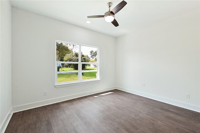 unfurnished room featuring dark hardwood / wood-style floors and ceiling fan