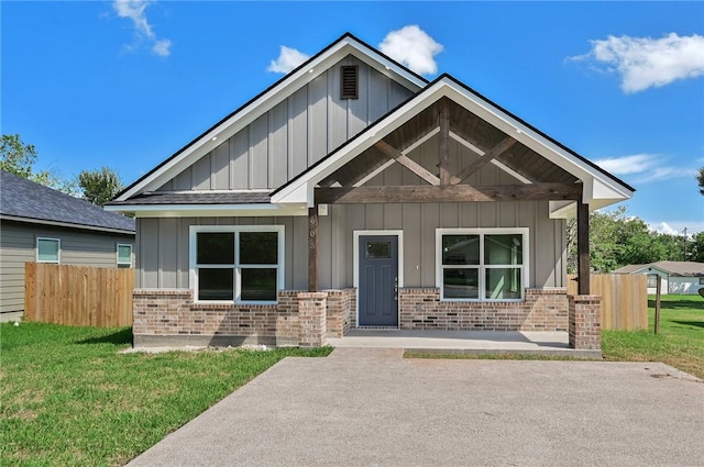 craftsman-style house with a porch and a front lawn