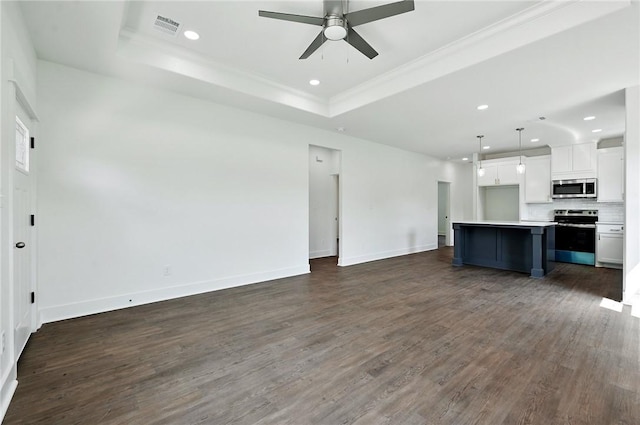 unfurnished living room with dark hardwood / wood-style flooring, ceiling fan, a raised ceiling, and ornamental molding