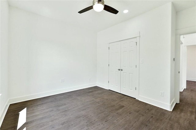 unfurnished bedroom with a closet, ceiling fan, and dark hardwood / wood-style flooring