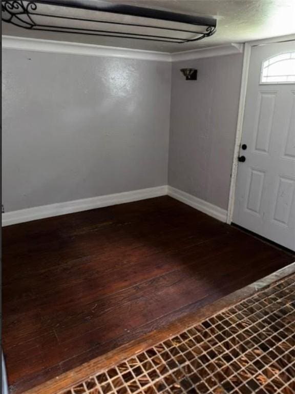 foyer entrance featuring baseboards and hardwood / wood-style floors