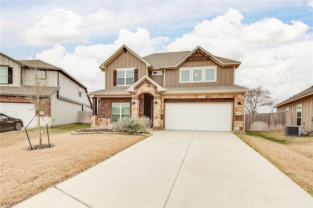 view of front of property featuring a front lawn, cooling unit, and a garage