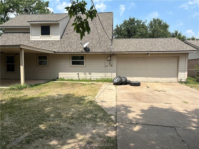 view of front of house featuring a garage and a front lawn