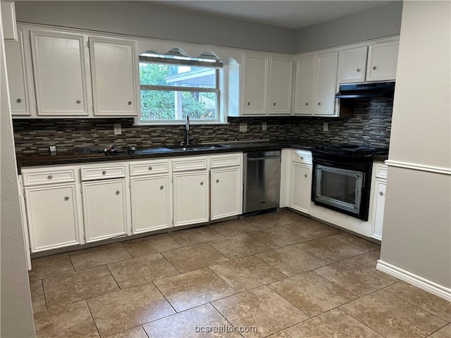 kitchen with stainless steel dishwasher, decorative backsplash, black range oven, and sink