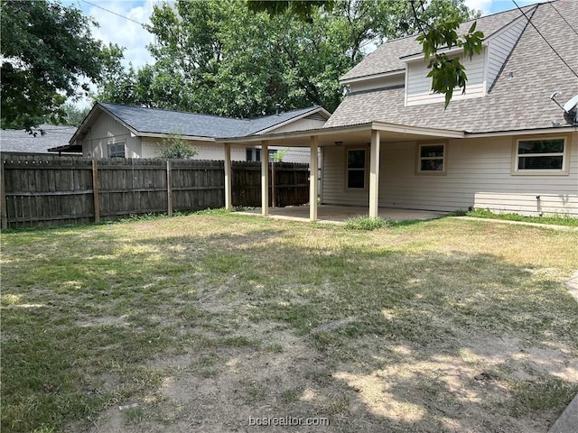 rear view of property featuring a lawn and a patio