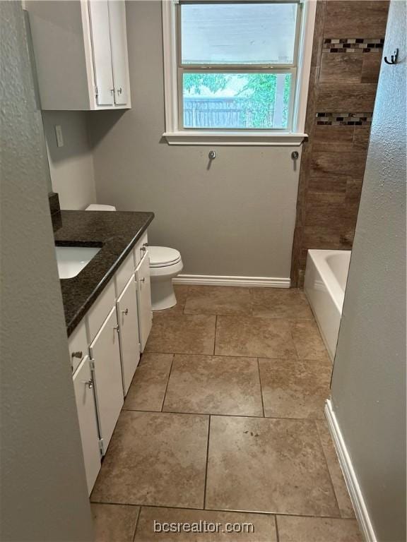 full bathroom with tile patterned flooring, vanity, toilet, and tiled shower / bath