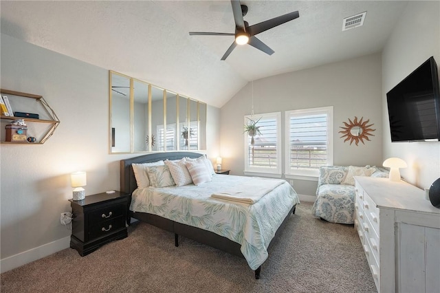 carpeted bedroom with a textured ceiling, vaulted ceiling, and ceiling fan