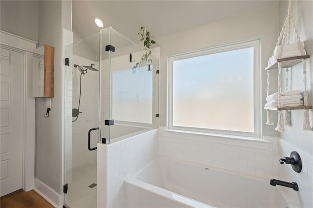 bathroom featuring shower with separate bathtub