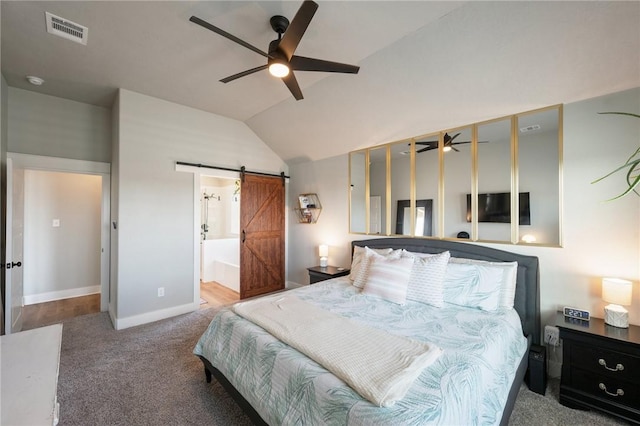 carpeted bedroom featuring ceiling fan, a barn door, and lofted ceiling