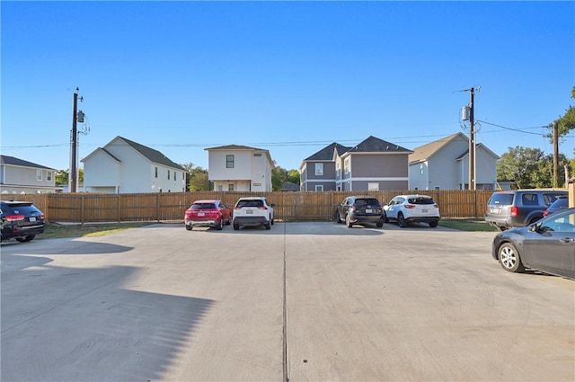 303 Luther St, College Station, TX 77840 - uncovered parking lot featuring fence and a residential view