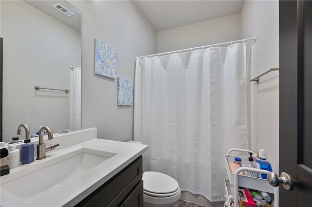 303 Luther St, College Station, TX 77840 - bathroom featuring toilet, wood finished floors, vanity, and a shower with shower curtain