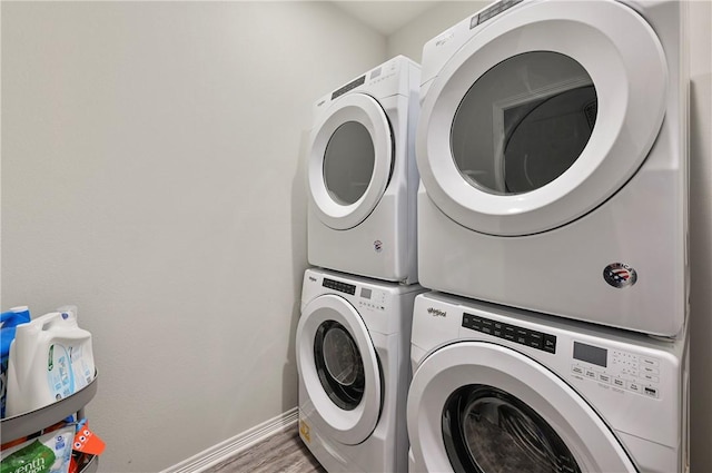 303 Luther St, College Station, TX 77840 - laundry room with estacked washer and dryer, baseboards, and light wood finished floors