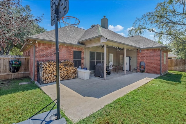 back of house featuring a patio, ceiling fan, and a lawn