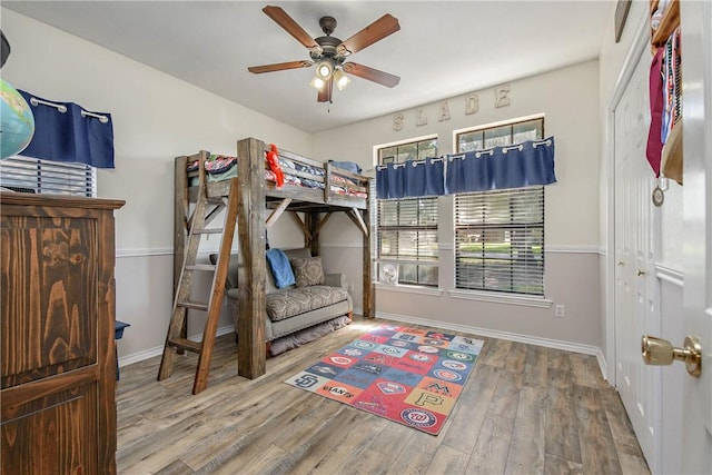 bedroom with hardwood / wood-style floors and ceiling fan