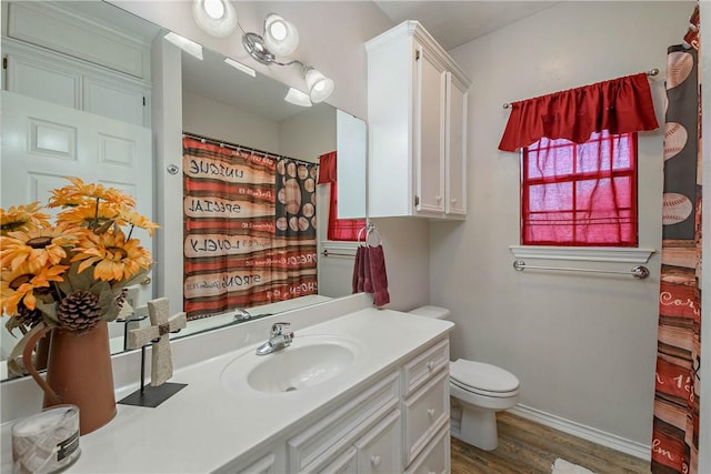 bathroom with a shower with curtain, toilet, vanity, and hardwood / wood-style flooring