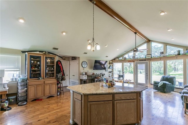180 Fcr 797, Donie, TX 75838 - kitchen featuring open floor plan, light wood-type flooring, a ceiling fan, decorative light fixtures, and brown cabinetry