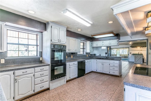 180 Fcr 797, Donie, TX 75838 - kitchen featuring black appliances, a peninsula, a sink, dark countertops, and tasteful backsplash