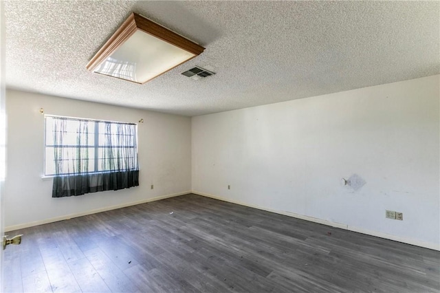 180 Fcr 797, Donie, TX 75838 - unfurnished room featuring a textured ceiling, dark wood finished floors, and baseboards